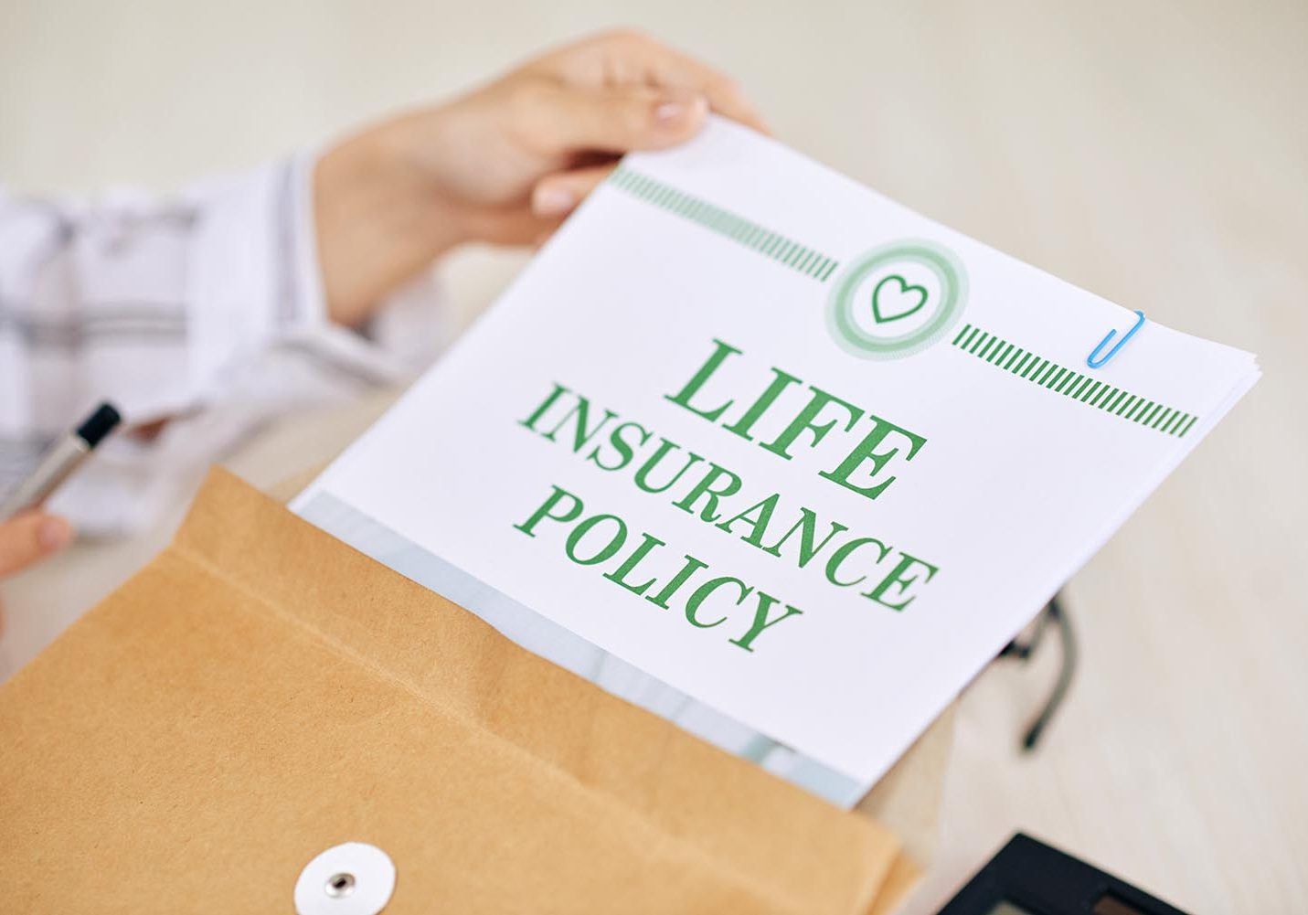 Crop worker of agency holding paper document of life insurance policy in envelope